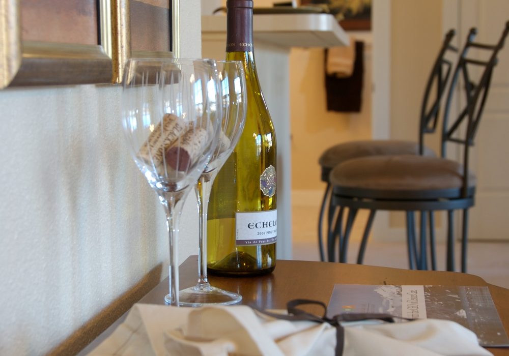 Close-up of wine glasses and a bottle in a cozy room