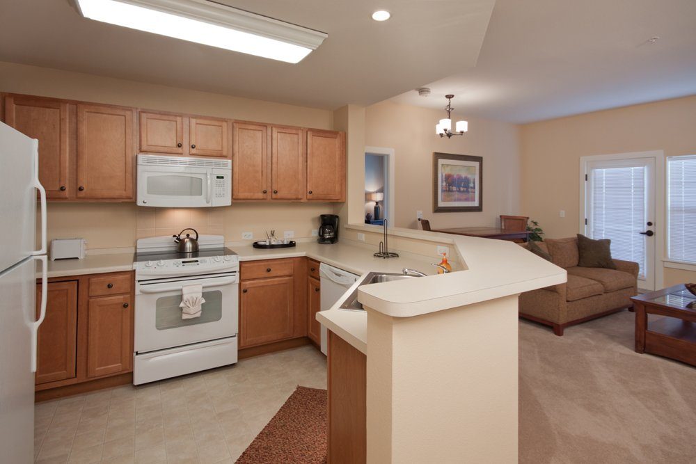 Bright kitchen and living area in a senior living apartment