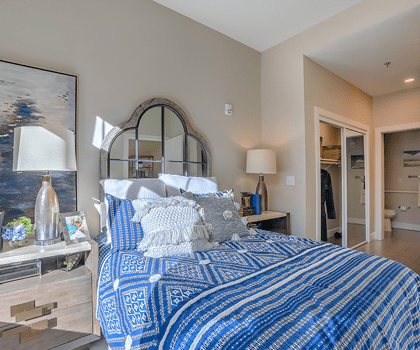 A cozy private resident room with blue decor
