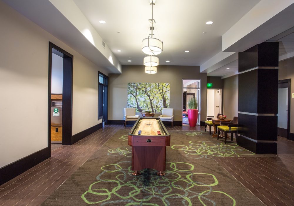 Interior view of a common area with a shuffleboard table