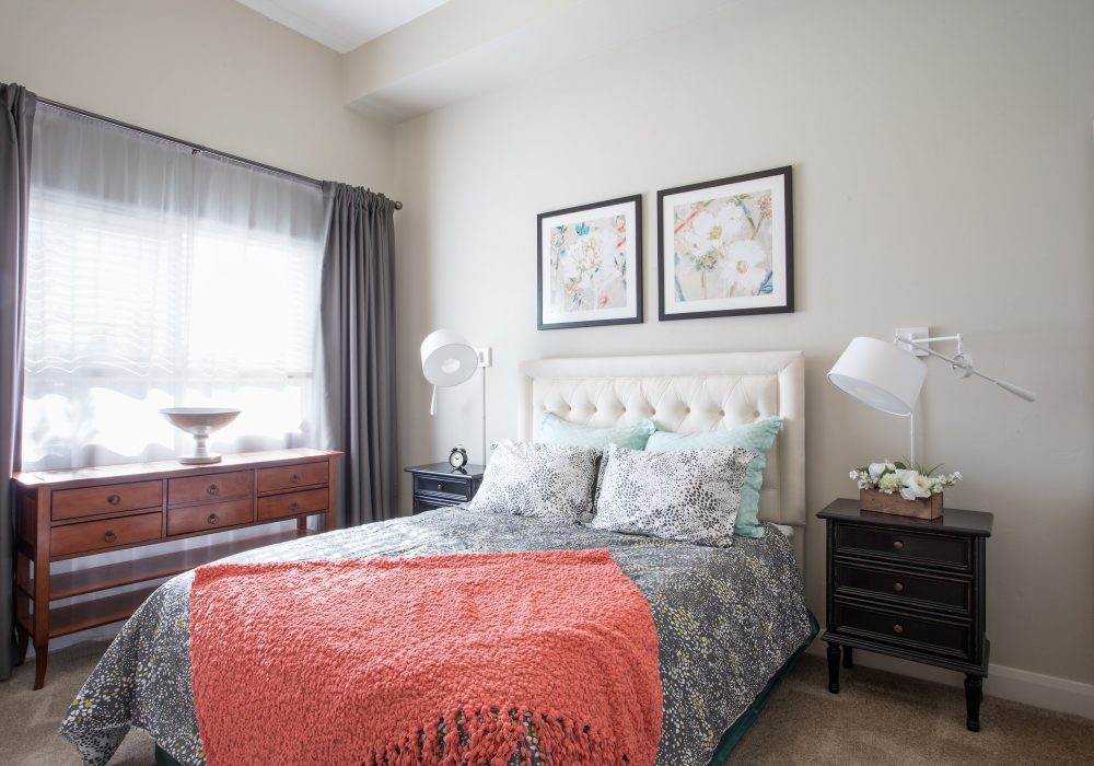 A beautifully decorated resident room with bed and decor