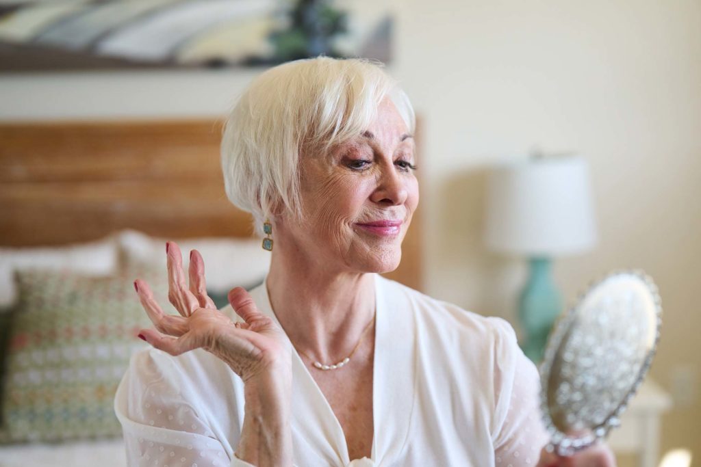 Senior woman enjoying her reflection in a mirror