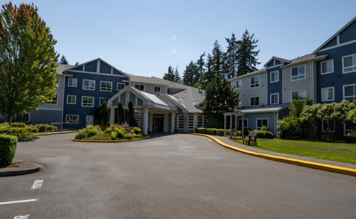 Exterior view of the assisted living facility with gardens