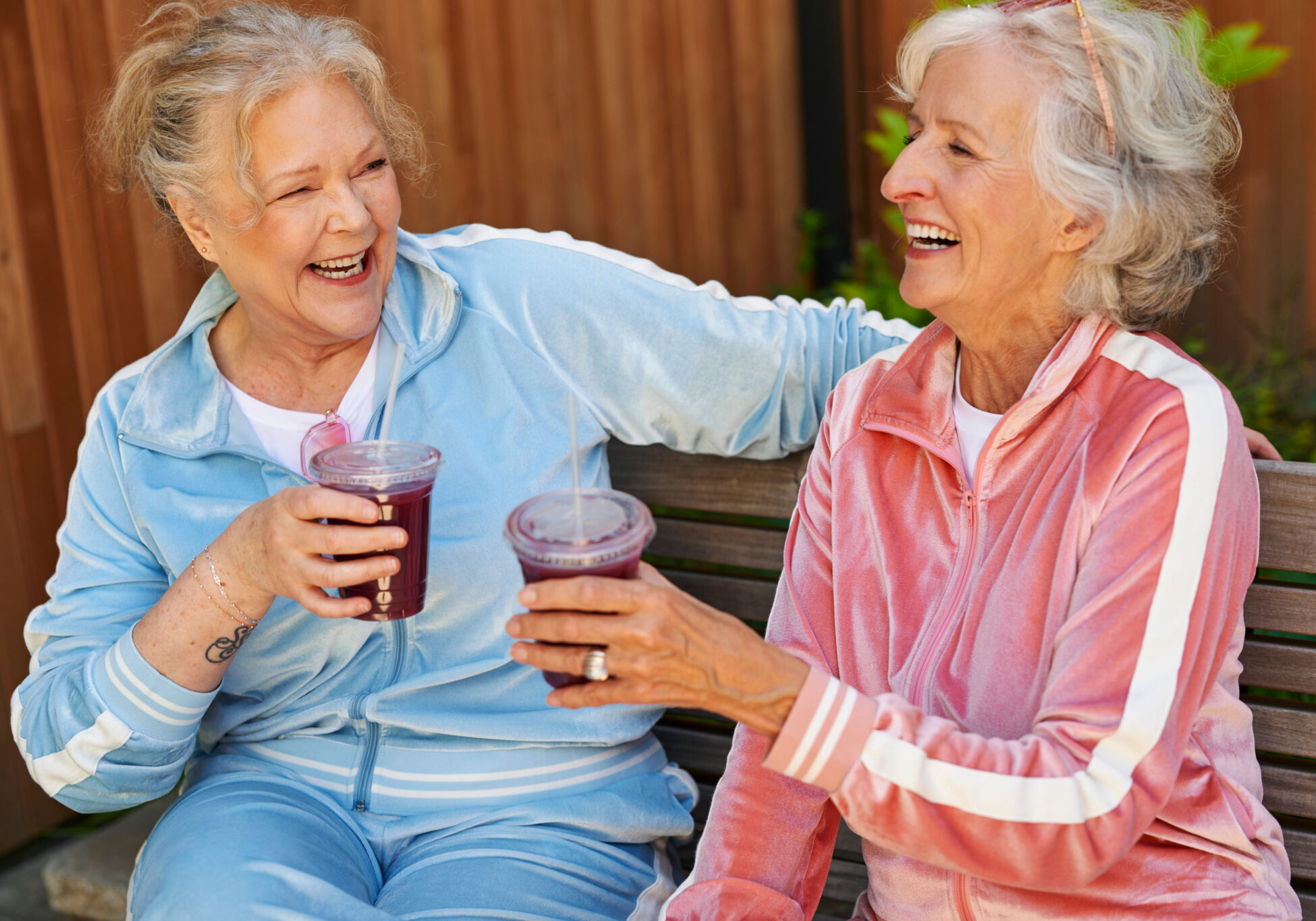 Two residents enjoying smoothies and laughing