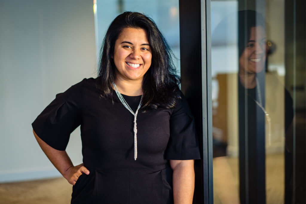 Staff member smiling in an interior space
