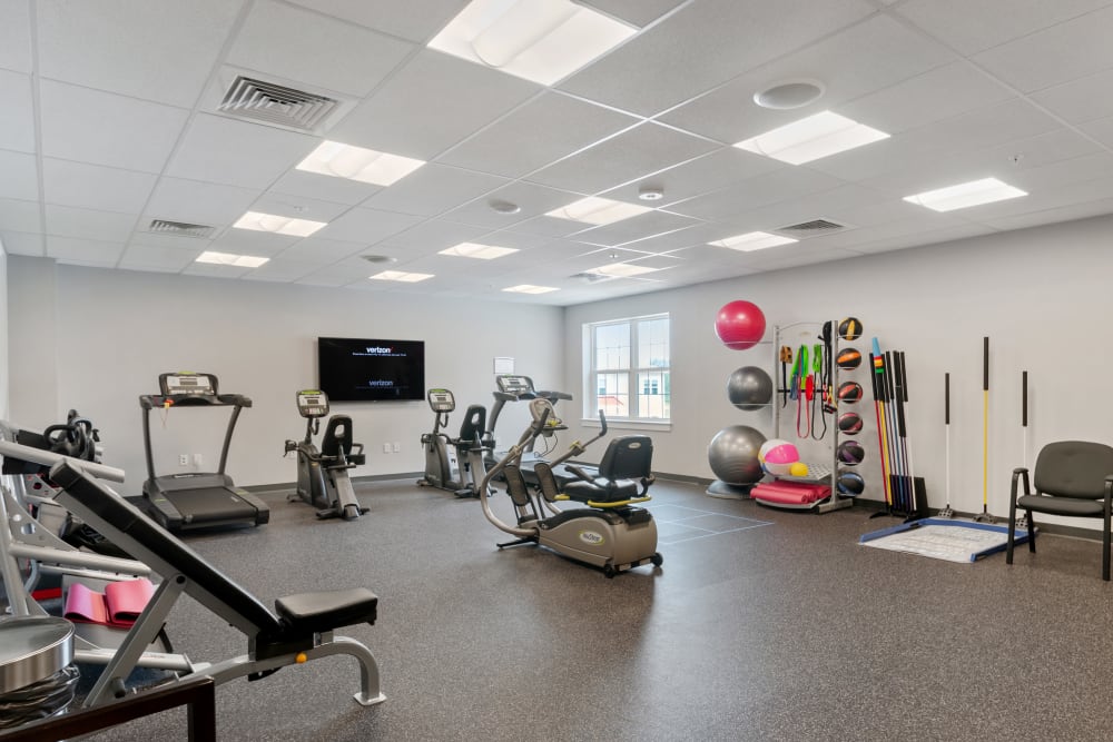 Fitness room with exercise equipment and mats