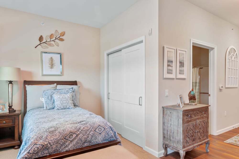 Cozy interior view of a resident room with bed and decor