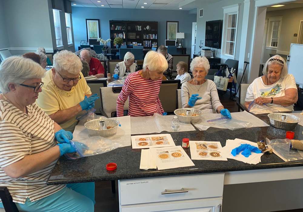 Residents engaged in a cooking activity at a common area