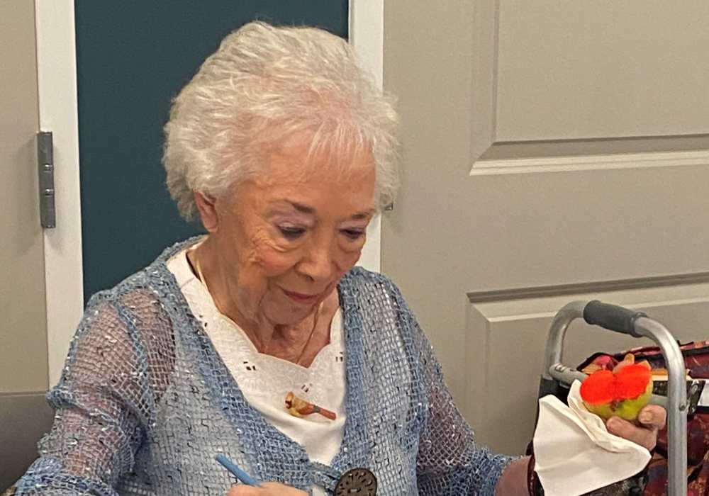 Resident enjoying a dessert in an activity area
