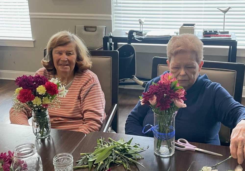 Residents participating in a floral arrangement activity