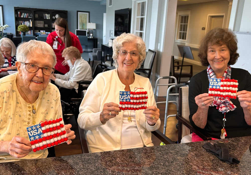 Residents participating in a craft activity with American flag decorations