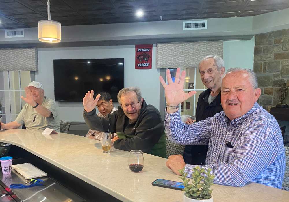 Residents socializing and enjoying drinks at a bar area
