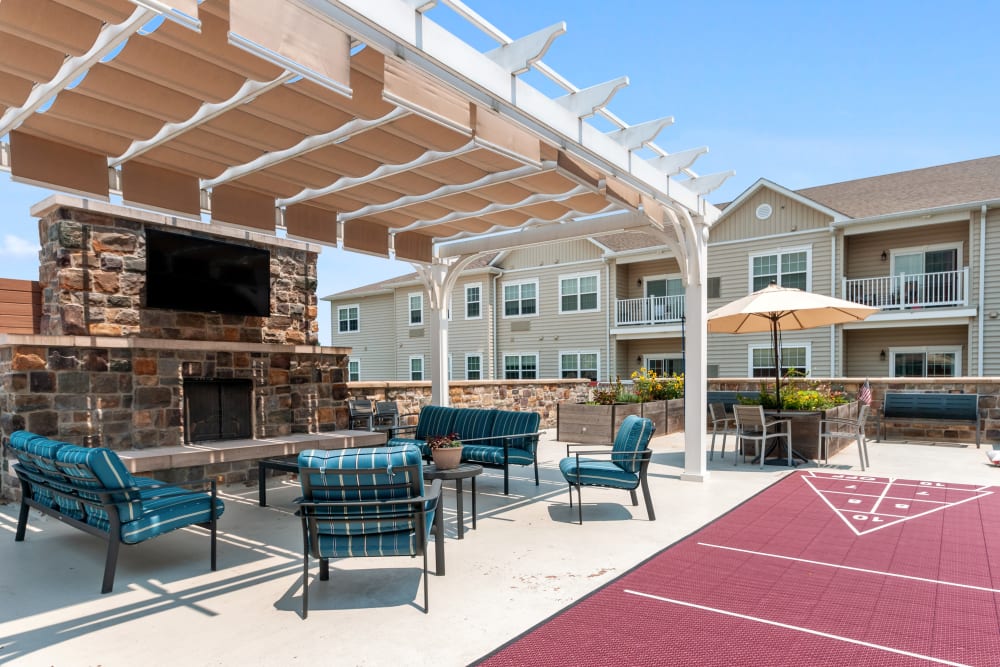 Outdoor seating area with a fireplace and games