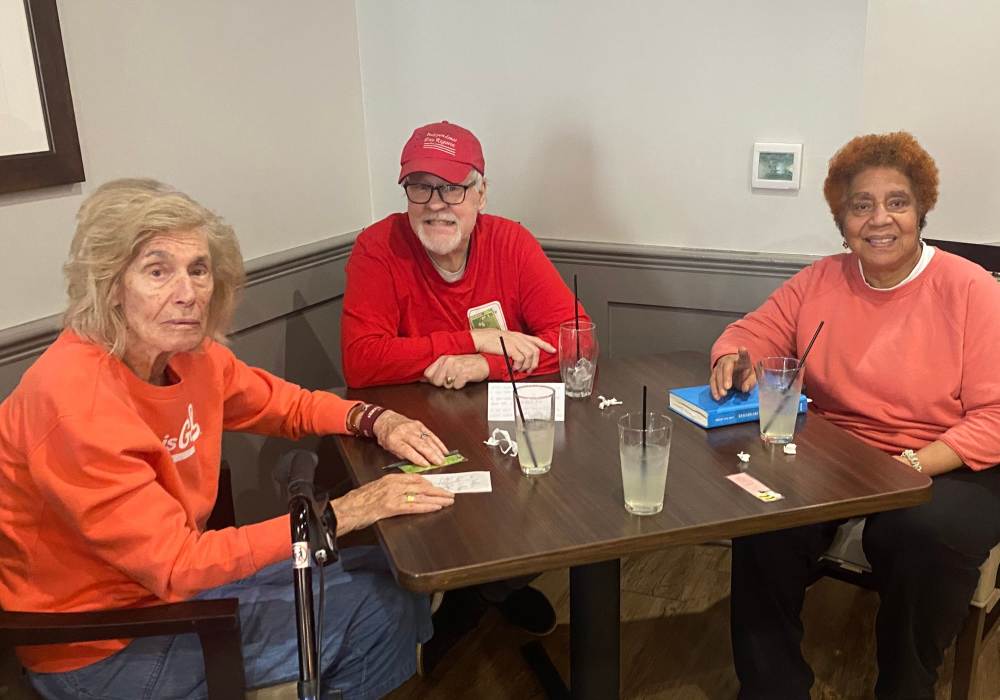 Residents playing a card game at a table