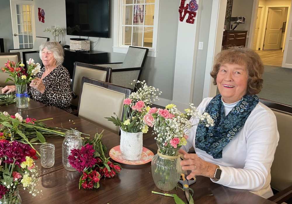 Residents creating flower arrangements in a common area