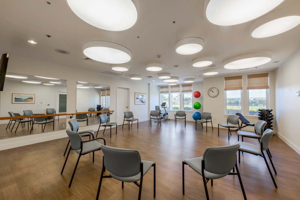 Bright activity room with seating and exercise equipment