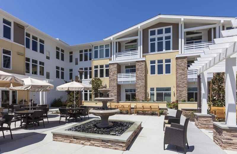 Exterior view of the facility with patio and fountain