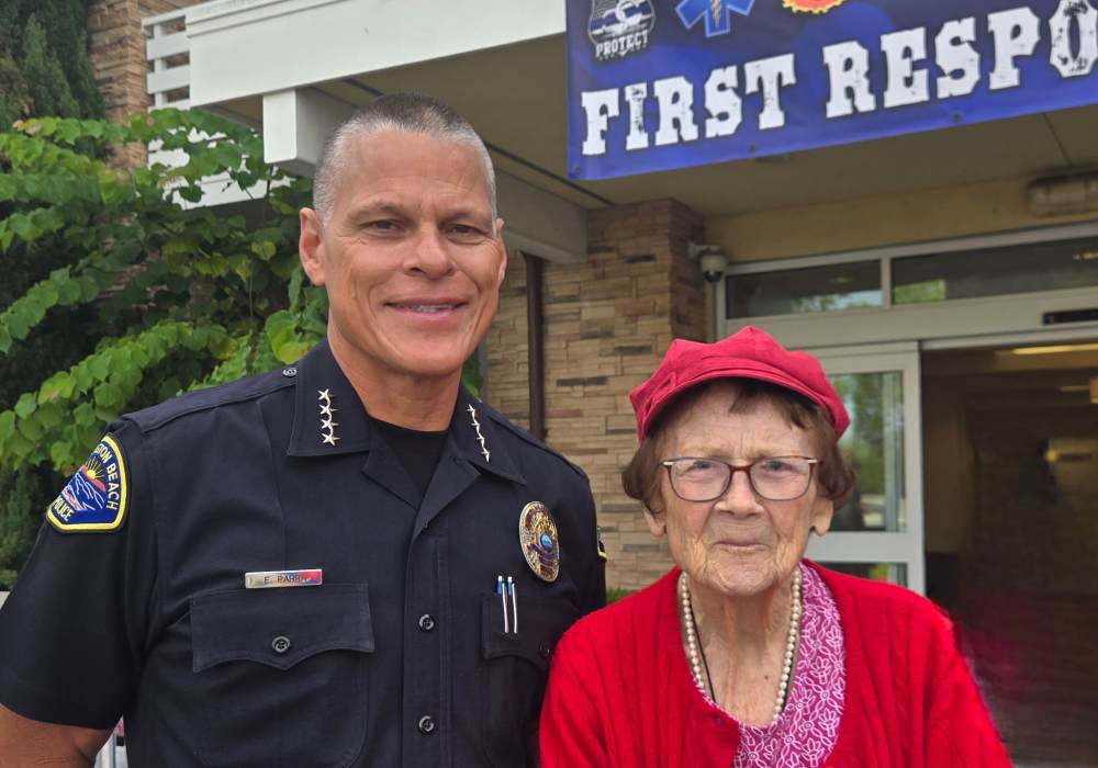 Resident posing with a police officer outside the facility