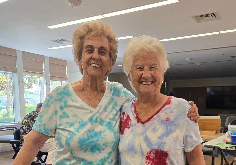 Two smiling residents in a common area