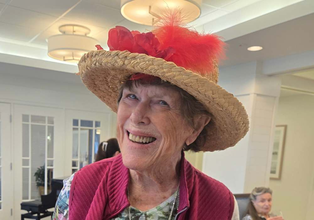Resident wearing a festive hat in a common area