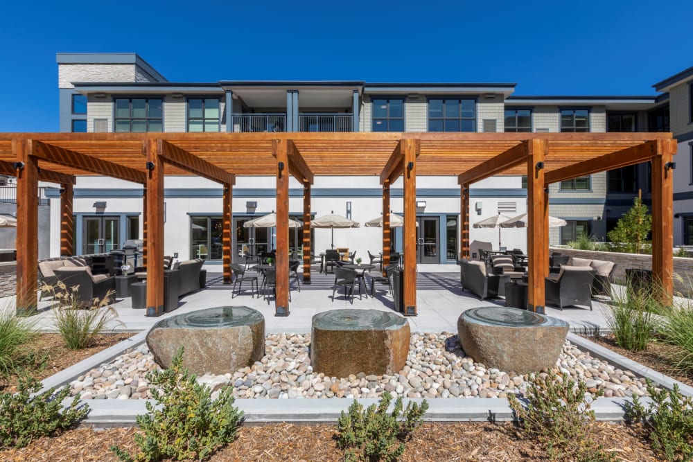Outdoor seating area with pergola and stone features