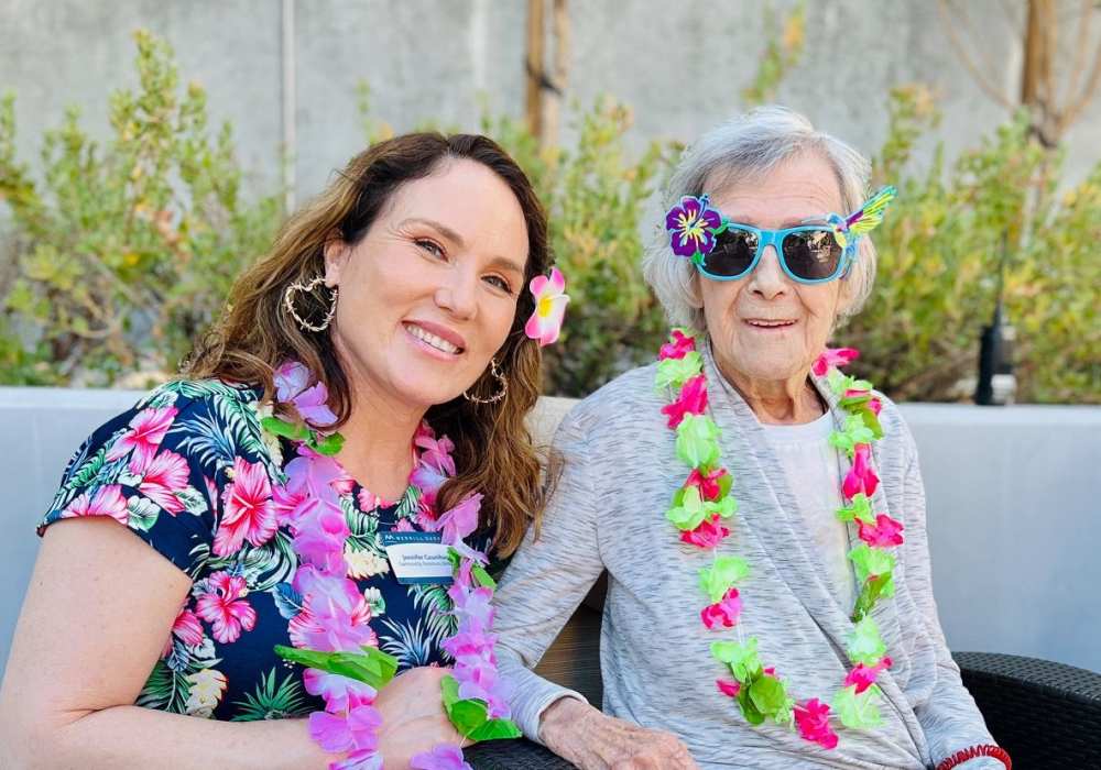 Resident and staff member enjoying a themed event outdoors