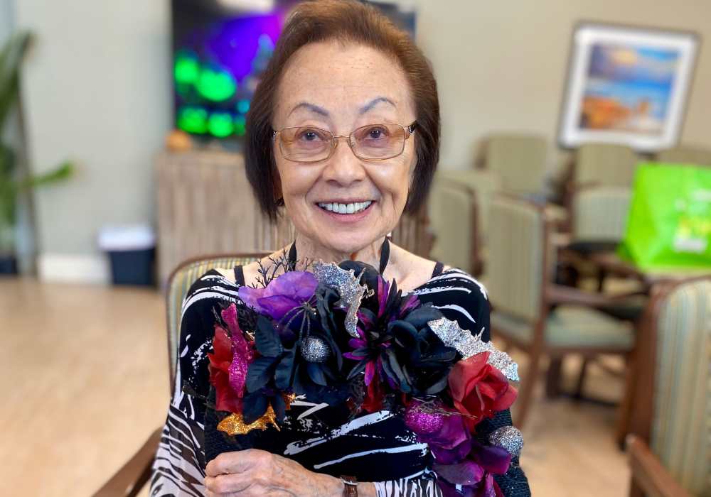 Resident holding a colorful bouquet in a common area