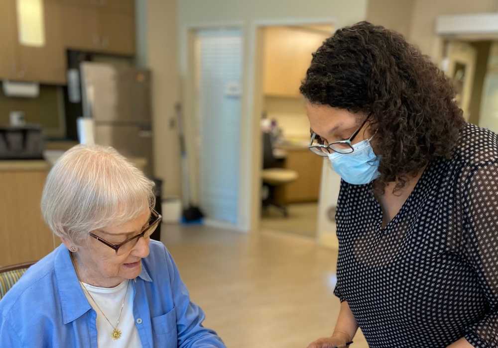 Staff member assisting a resident in a common area