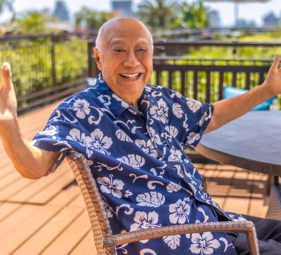 Senior resident enjoying a sunny outdoor patio