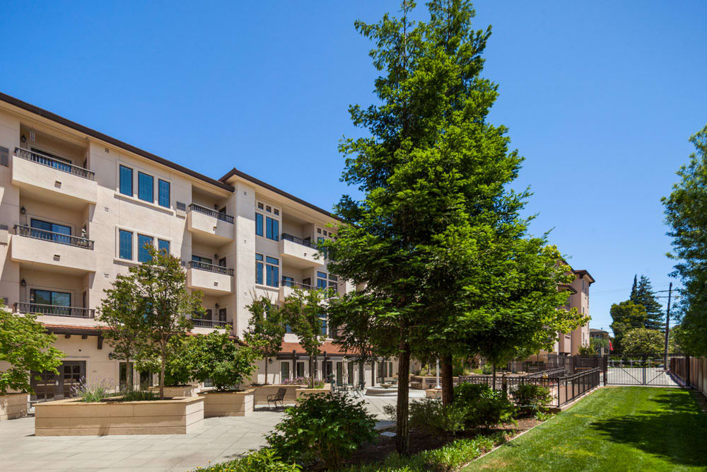 Exterior view of a senior living facility with landscaping.