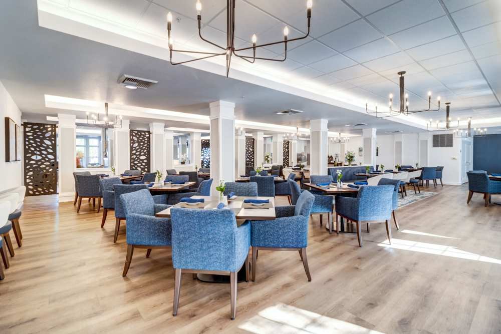 Bright dining room with blue chairs and tables