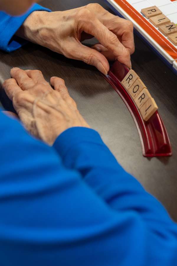 Resident playing a word game with tiles
