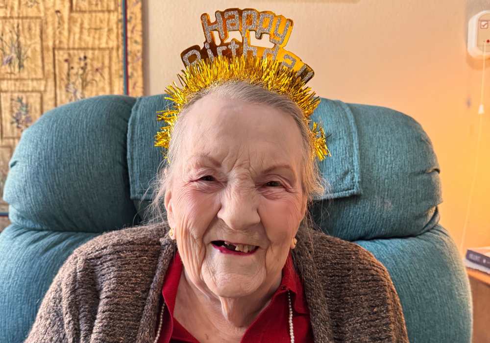 Resident celebrating birthday in a cozy chair