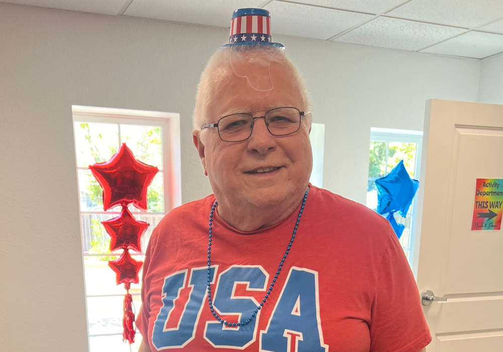 Resident celebrating with patriotic attire in activity room