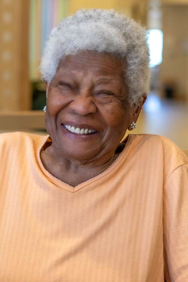 Smiling resident in a cheerful indoor setting