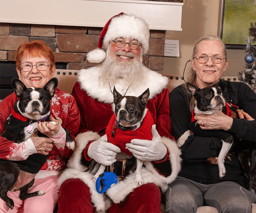 Residents celebrating with Santa and dogs