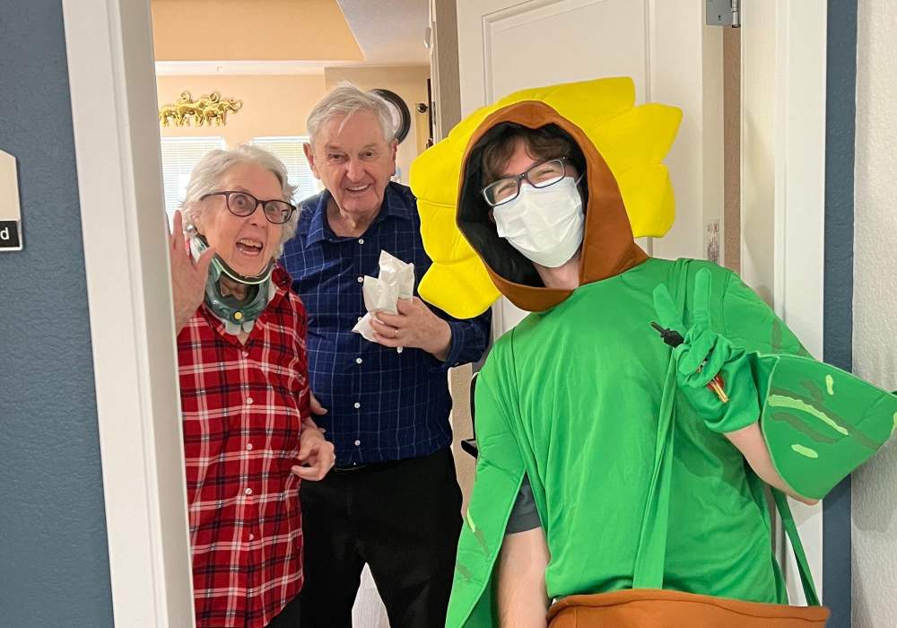 Residents and a staff member celebrating at the doorway