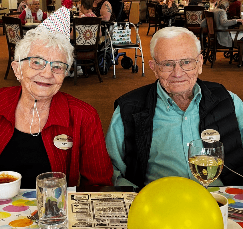 Residents celebrating with party hats and food