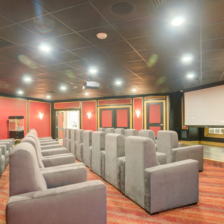 Interior of a theater room with seating and a projector
