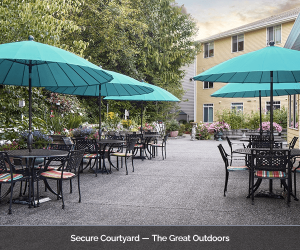 Secure courtyard with tables and umbrellas