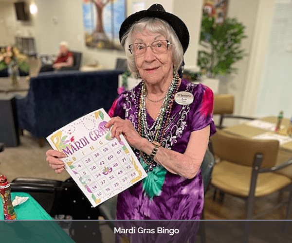 Resident enjoying Mardi Gras bingo activity