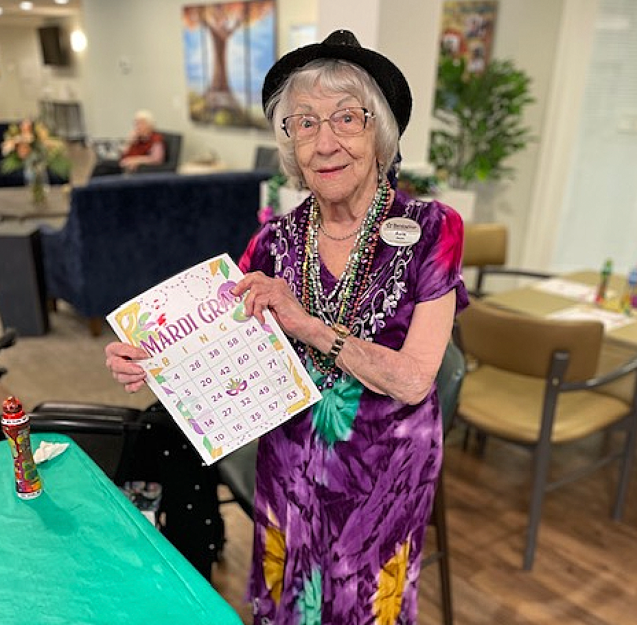 Resident celebrating Mardi Gras with a calendar