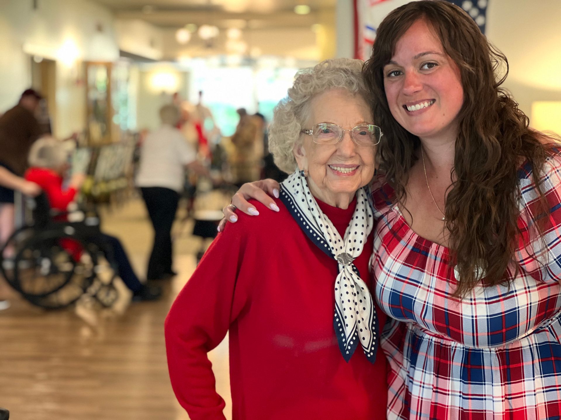 A resident and staff member smiling together in a common area
