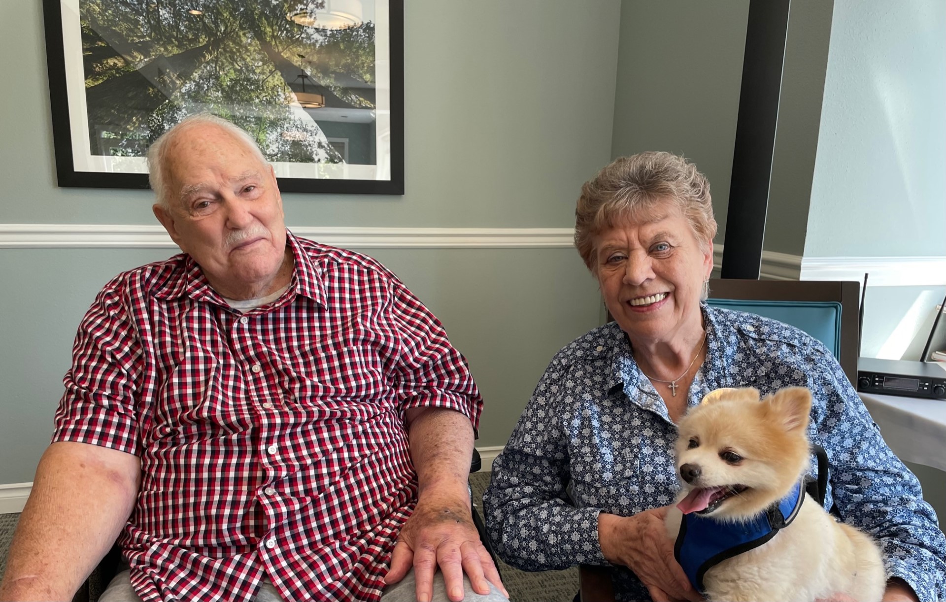 Residents enjoying time with a dog in the facility's interior