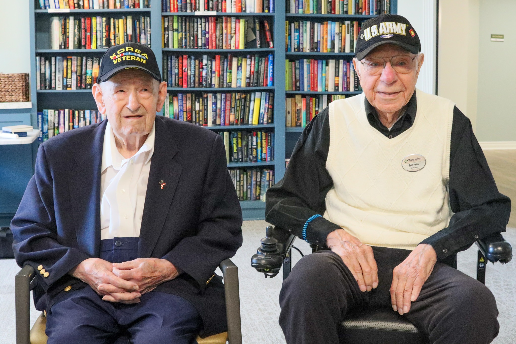 Two veterans in a common area of a memory care facility