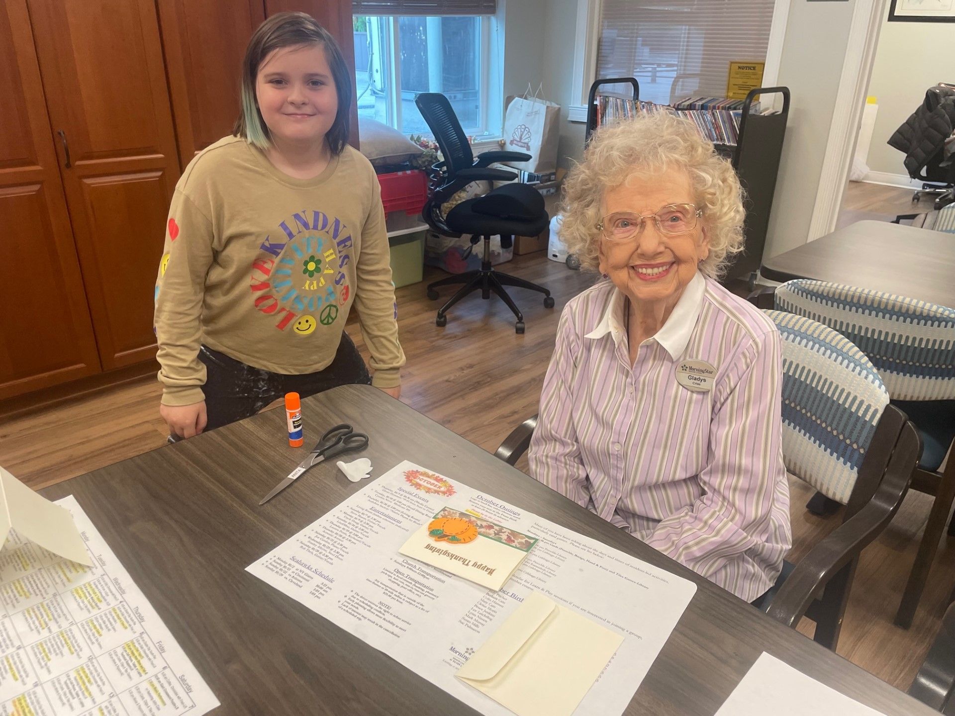 An elderly woman and a child engaged in a creative activity
