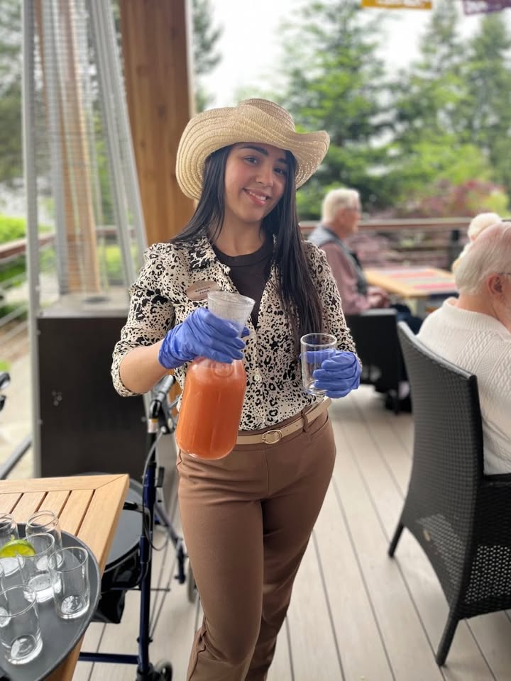 Staff member serving drinks on a patio