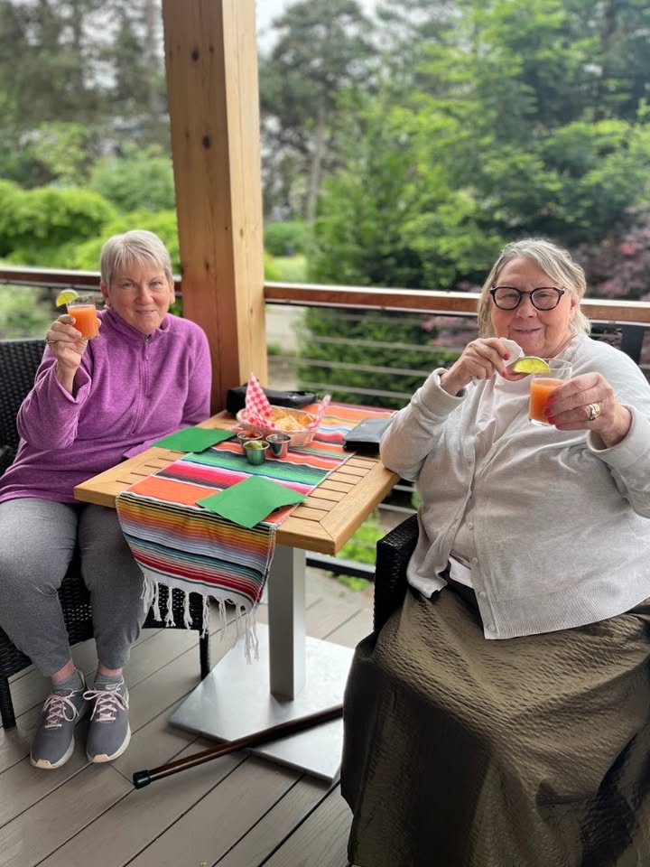 Two residents enjoying mocktails on a outdoor patio