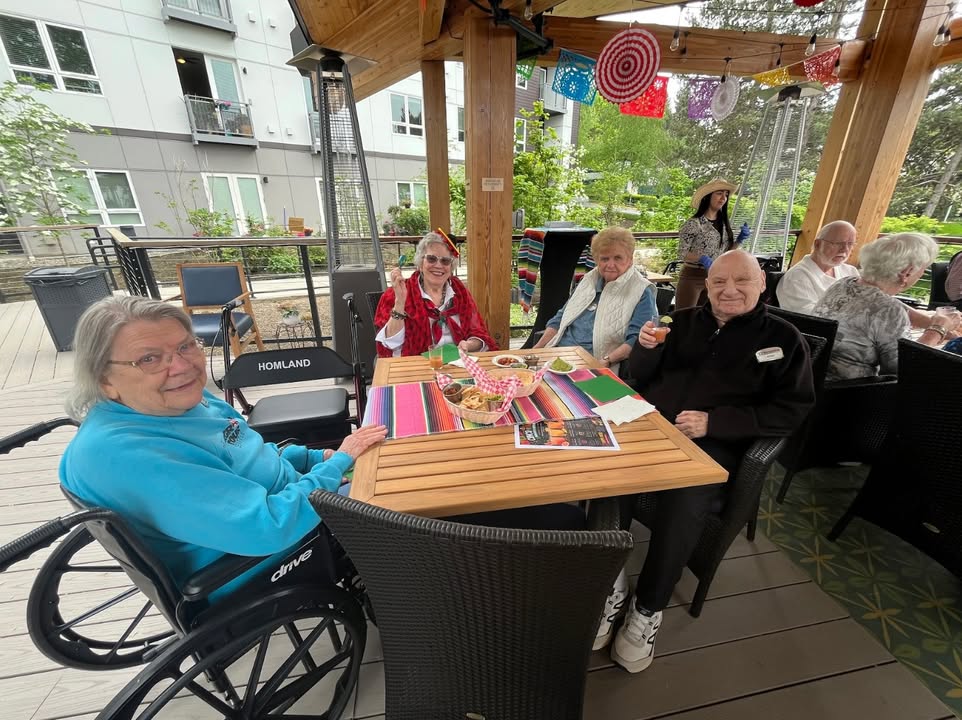 Residents enjoying a meal outdoors on a patio