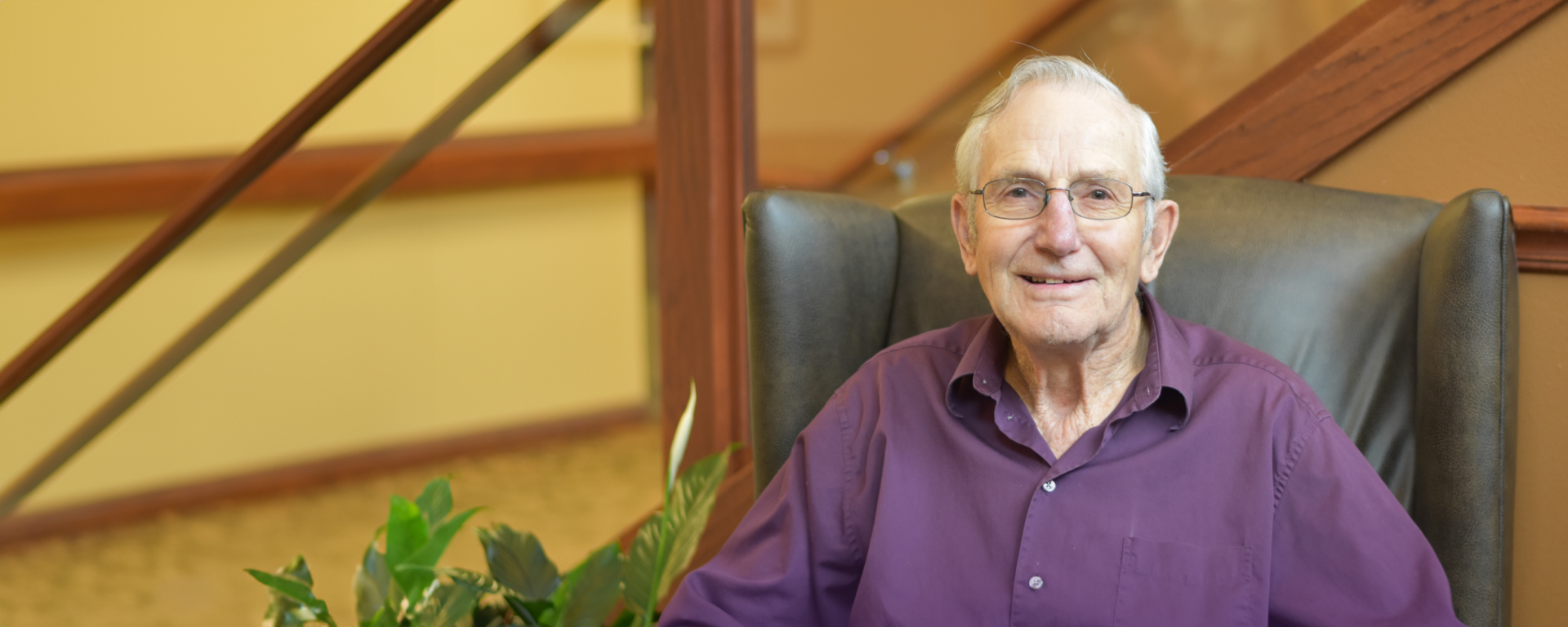 Senior resident smiling in a comfortable chair